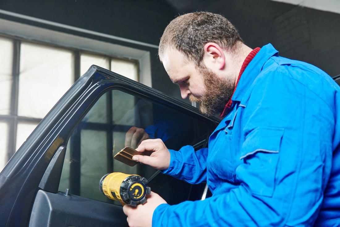 Person repairing a driver's side window.